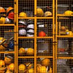 Safety Equipment - a rack filled with lots of yellow hard hats