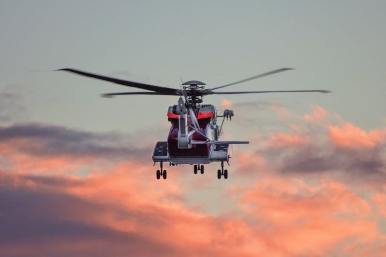 Rescue Operation - red and white hovering helicopter in mid-air photography