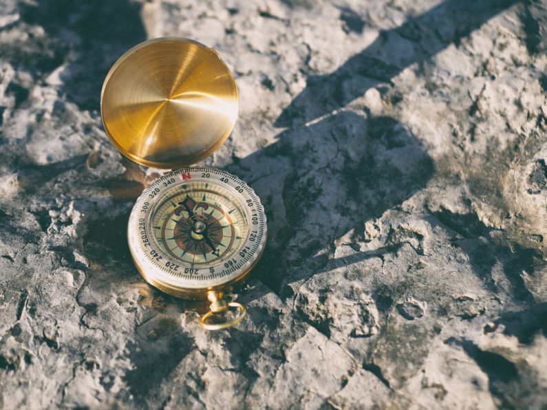 Navigational Compass - gold-colored compass on stone