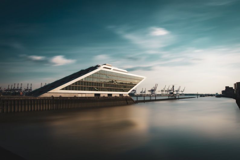 Futuristic Yacht - white and brown building near body of water during daytime