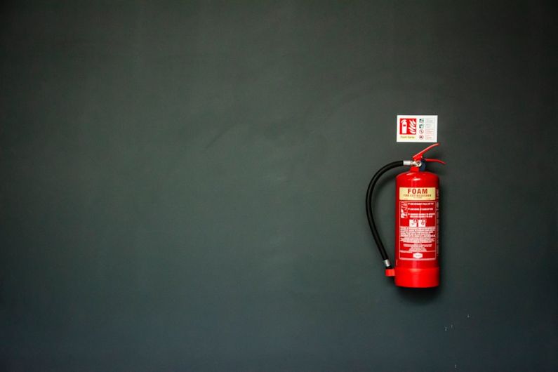 Fire Extinguisher - red fire extinguisher on gray wall