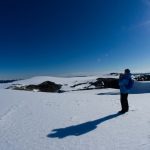 Antarctic Adventure - a man standing on top of a snow covered slope
